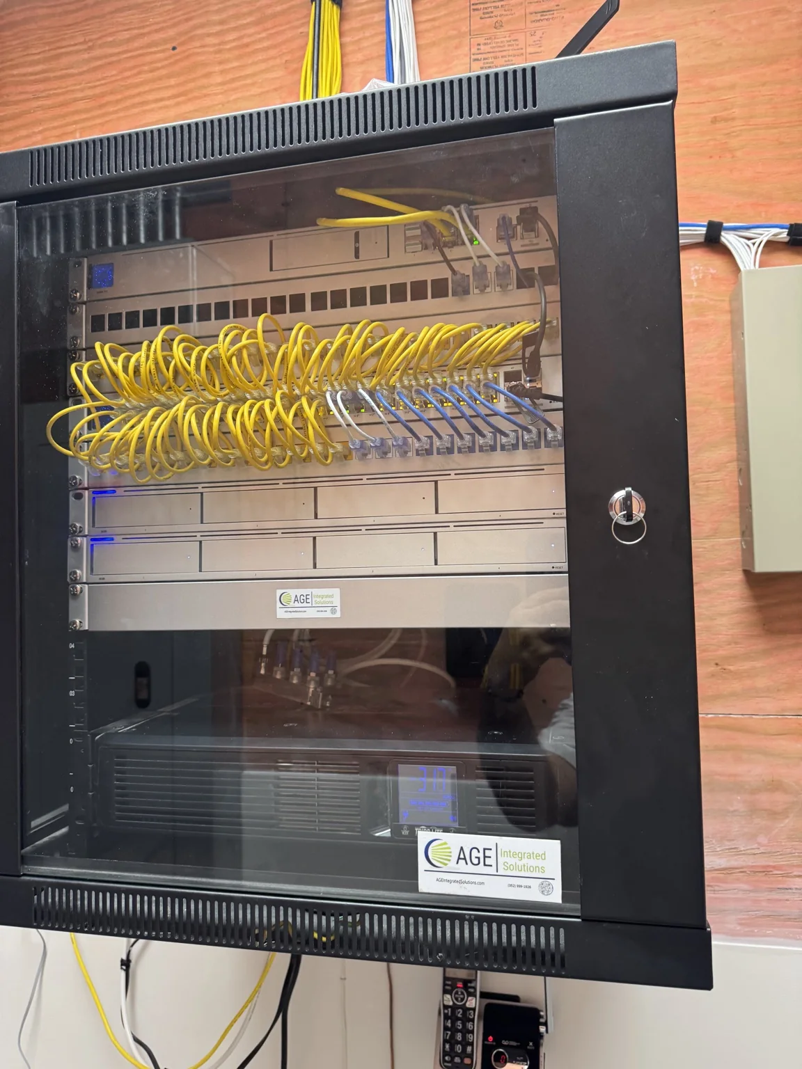 AGE-installed commercial network rack with organized switching and cabling